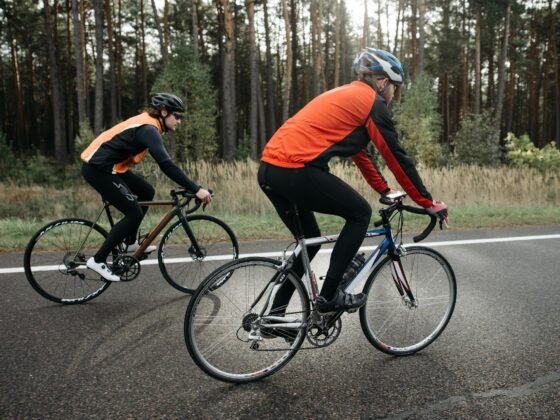 Two cyclists riding on road