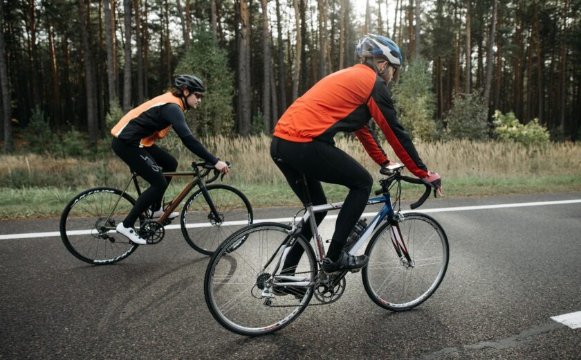 Two cyclists riding on road