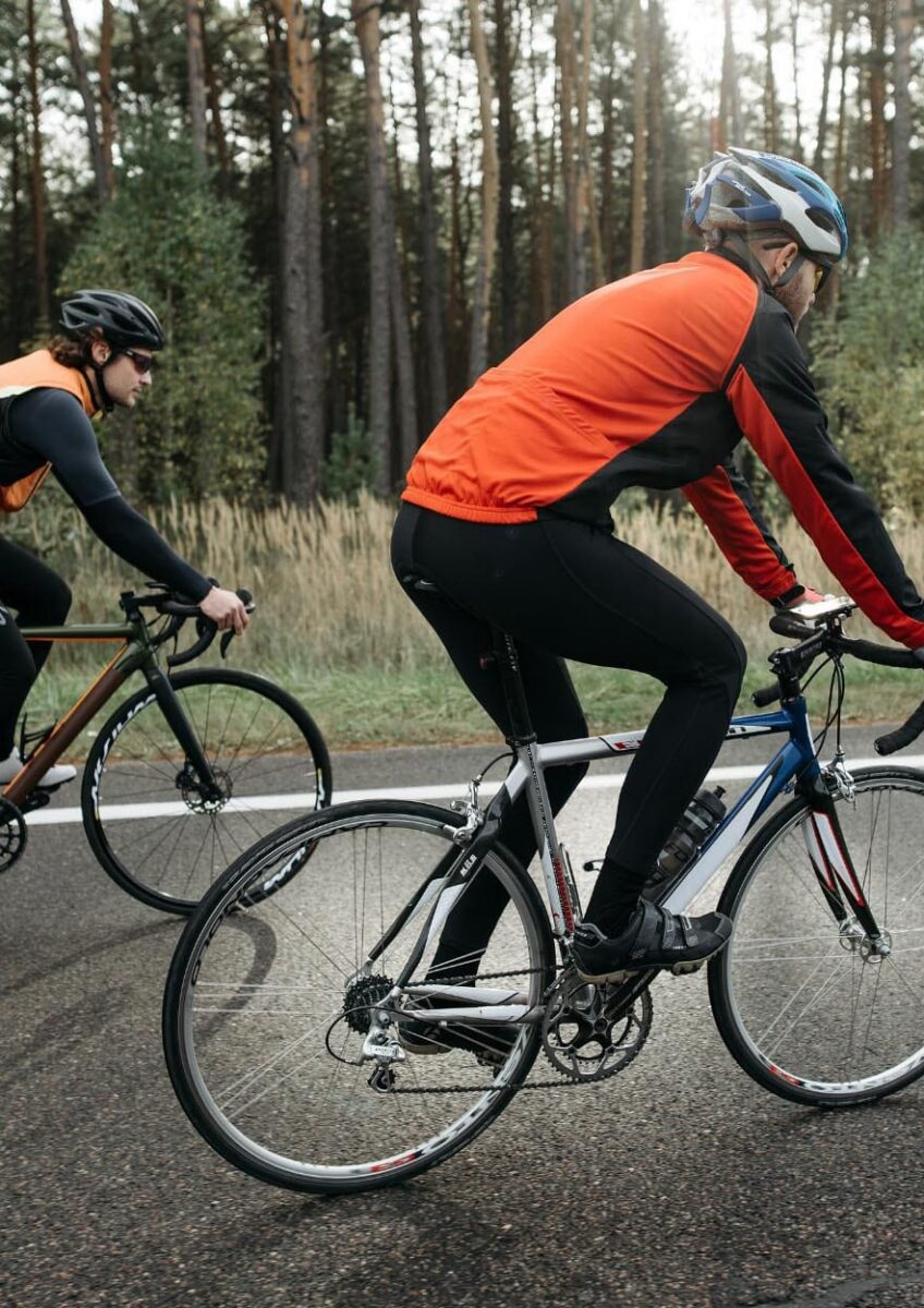 Two cyclists riding on road