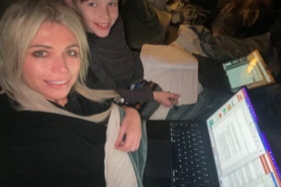 Woman and child working on laptop at home