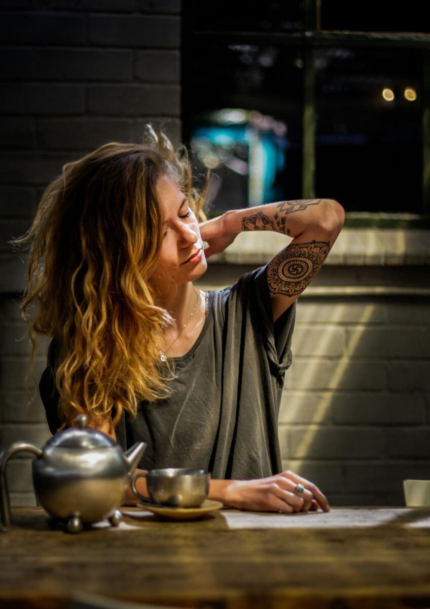 Woman clutching her back at kitchen table