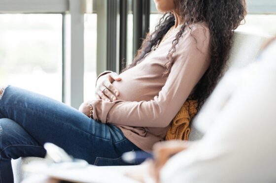 Woman holding pregnant belly