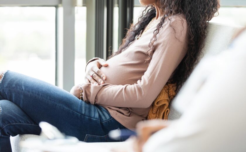 Woman holding pregnant belly