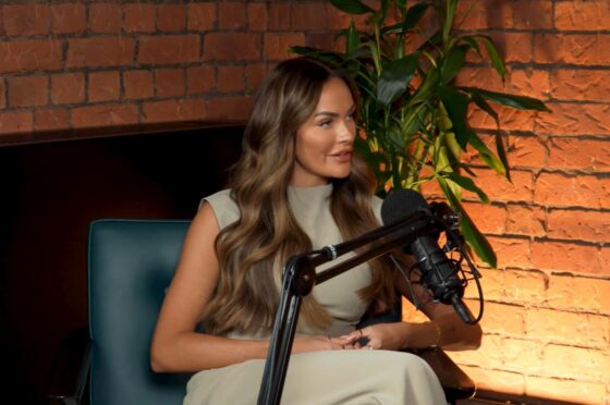 Woman speaking into podcast microphone