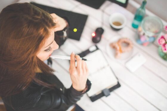 Woman working at desk with notebook