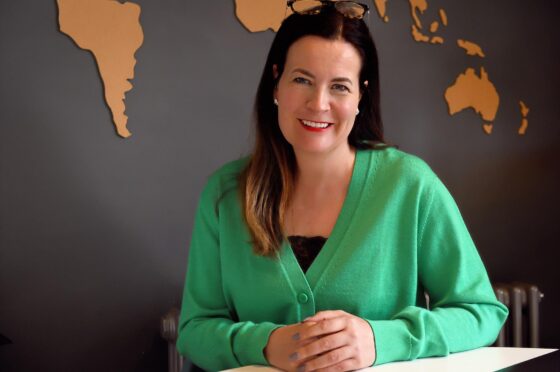 Zoe Holland seated at desk
