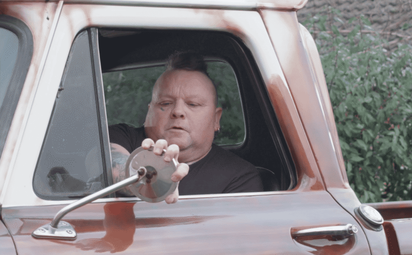 Robert driving a red car