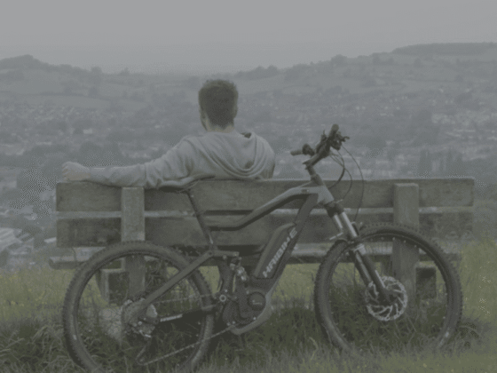 Stuart sat on bench with bike