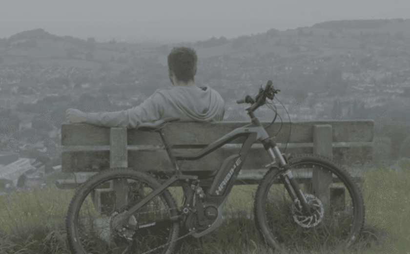 Stuart sat on bench with bike