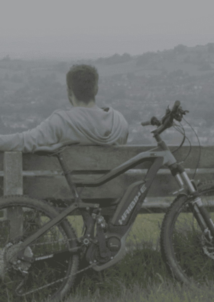 Stuart sat on bench with bike