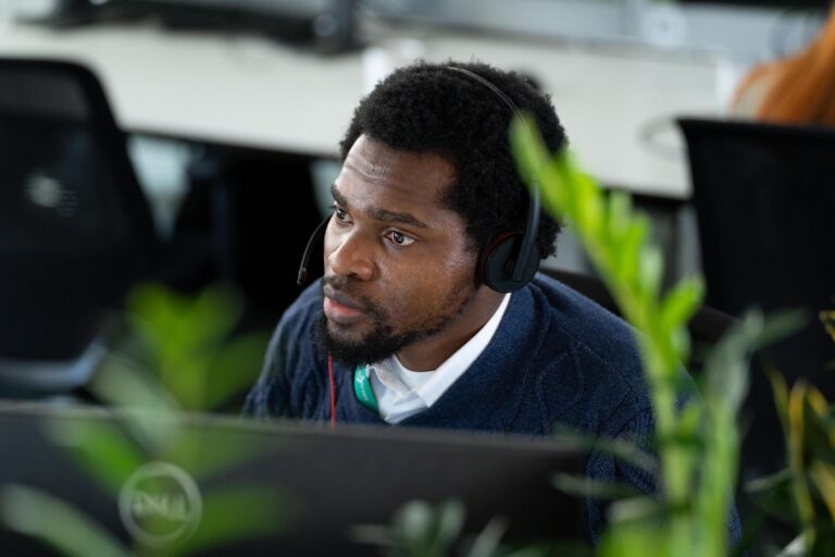 Male with headset sat at desk