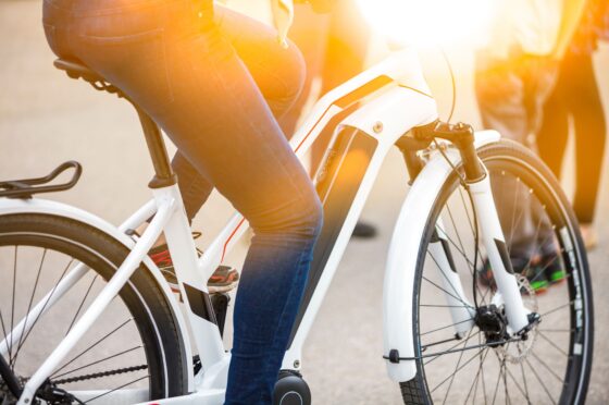 Close-up of battery pack on modern white electric bicycle