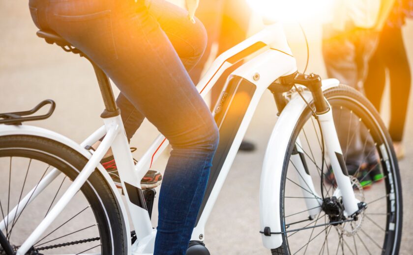 Close-up of battery pack on modern white electric bicycle