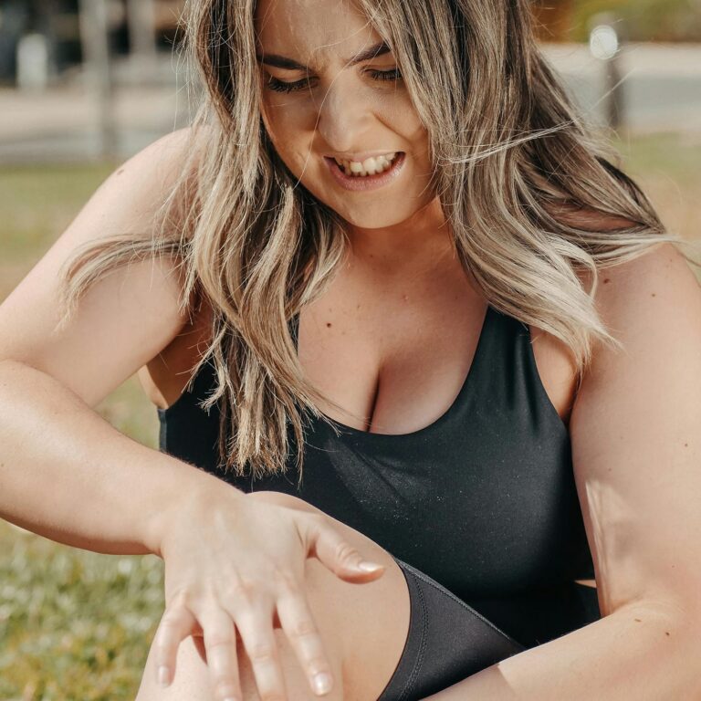 Girl holding her knee in pain